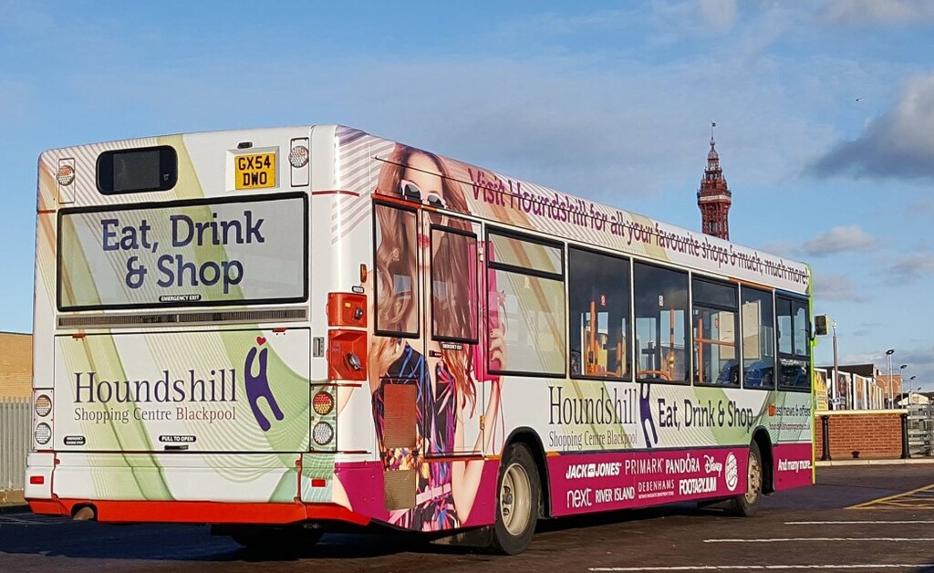 Bus outside a church with BP Insurance livery